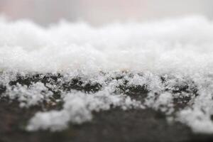 Snow lies on the old cement railing of the balcony photo
