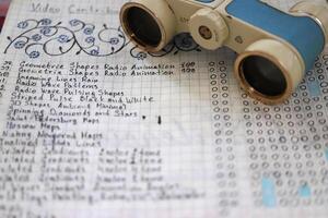Sheet of notebook with to-do list and theater binoculars photo