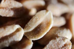 A handful of salted peanuts background. Macro closeup. photo