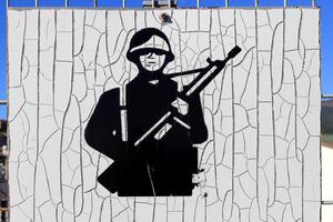 Solder with weapon weathered sign photo