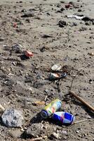 Lot of garbage on the sand. Dirty summer beach background. photo