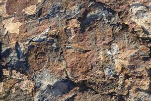 Rough bust fractured stone texture material macro closeup. photo