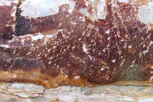 Rust textured stone rough material background. photo