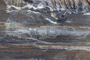 Rough bust fractured detail stone wall structure surface. photo