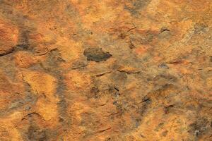 Rust textured stone rough material background. photo