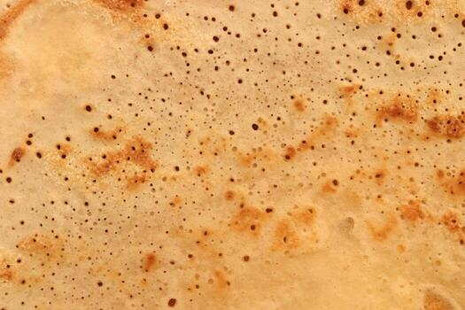 Light toasted traditional desert pancake pattern texture. Macro closeup. photo