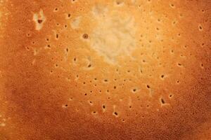 Backed traditional desert pancake pattern texture. Macro closeup. photo