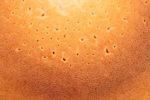 Backed sweet and warm pancake surface texture breakfast. Macro closeup. photo