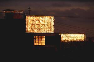 Sunlight reflects off the roof of a residential building photo