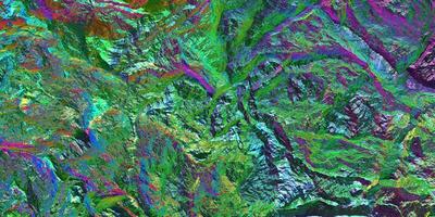 Chameleon stone rock surface texture. Holographic gradient background. Colored light on textured surface. photo