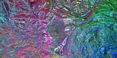 Colored light on textured surface. Chameleon stone rock surface texture. Holographic gradient background. photo