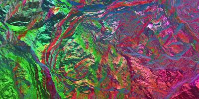 Colored light on textured surface. Chameleon stone rock surface texture. Holographic gradient background. photo