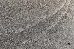 Sand texture pattern and stone. Summer beach background. photo