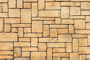 Masonry stone cladding wall texture. Geometric shapes surface background. photo