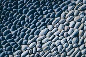 Lot of white masonry cladding pebble texture. Stones pattern background. photo