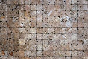 Square stones surface background. Travertine masonry tiles cladding wall texture. photo