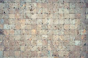 Square stones surface background. Travertine masonry tiles cladding wall texture. photo
