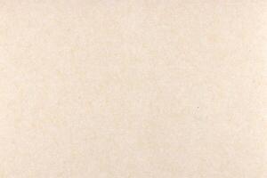 Decorative cream kraft paper texture. Decorated handmade craft paper background. Landscape horizontal orientation. photo