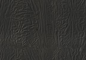 Seamless black crumple packaging pollution plastic bag texture background. photo