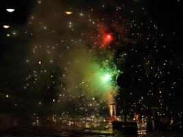 The colorful and beautiful fireworks show with the dark sky as background at night photo