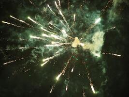 The colorful and beautiful fireworks show with the dark sky as background at night photo
