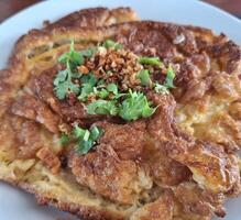Freshly prepared Asian deep-fried crispy egg omelet. photo