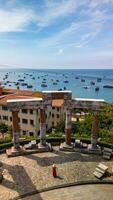 Woman in red dress and Vietnamese hat exploring Sunset Town on Phu Quoc Island photo