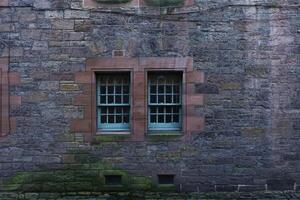 Vintage Window Embedded in Stone Wall of an Ancient House photo
