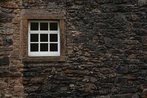 Vintage Window Embedded in Stone Wall of an Ancient House photo