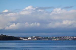 CRAMOND BEACH, A breathtaking view of Edinburgh city from the sea, with a picturesque landscape blending architecture, sky, and water photo