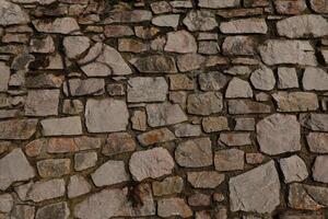 Stone Wall Texture Background, Abstract Architecture of Ancient Stone Structure in Brown and Gray, Rough Surface Pattern photo