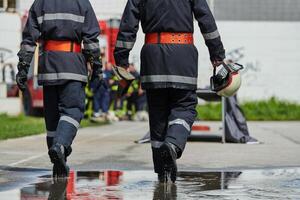 A team of confident and accomplished firefighters strides purposefully in their uniforms, exuding pride and satisfaction after successfully completing a challenging firefighting mission photo
