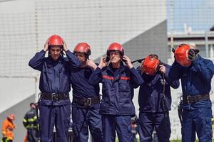A team of confident and accomplished firefighters strides purposefully in their uniforms, exuding pride and satisfaction after successfully completing a challenging firefighting mission photo