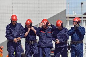 A team of confident and accomplished firefighters strides purposefully in their uniforms, exuding pride and satisfaction after successfully completing a challenging firefighting mission photo