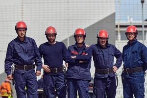 A team of confident and accomplished firefighters strides purposefully in their uniforms, exuding pride and satisfaction after successfully completing a challenging firefighting mission photo