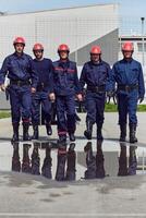 A team of confident and accomplished firefighters strides purposefully in their uniforms, exuding pride and satisfaction after successfully completing a challenging firefighting mission photo