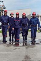 A team of confident and accomplished firefighters strides purposefully in their uniforms, exuding pride and satisfaction after successfully completing a challenging firefighting mission photo