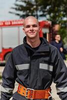Firefighter Stands Proudly with Professional Gear Beside Fire Truck After Intense Training photo