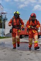 A team of confident and accomplished firefighters strides purposefully in their uniforms, exuding pride and satisfaction after successfully completing a challenging firefighting mission photo