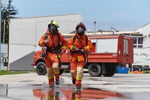 A team of confident and accomplished firefighters strides purposefully in their uniforms, exuding pride and satisfaction after successfully completing a challenging firefighting mission photo