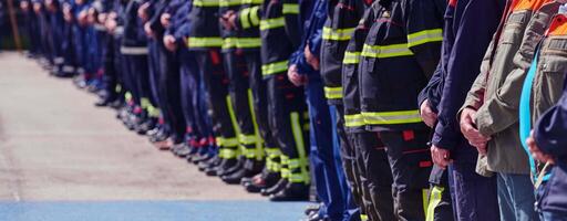 A group of firefighters lined up, saluting the flag, applauding in solidarity, and gearing up for intensive training sessions, showcasing their unwavering commitment to service and teamwork. photo