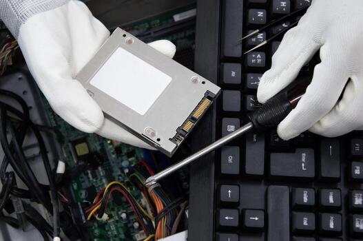 Top view. Technician inspecting computer, repairing computer circuits. photo