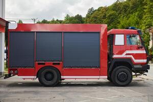 A state-of-the-art firetruck, equipped with advanced rescue technology, stands ready with its skilled firefighting team, prepared to intervene and respond rapidly to emergencies, ensuring the safety photo