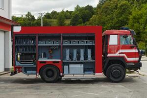 A state-of-the-art firetruck, equipped with advanced rescue technology, stands ready with its skilled firefighting team, prepared to intervene and respond rapidly to emergencies, ensuring the safety photo