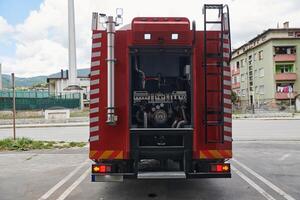 A state-of-the-art firetruck, equipped with advanced rescue technology, stands ready with its skilled firefighting team, prepared to intervene and respond rapidly to emergencies, ensuring the safety photo