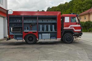 A state-of-the-art firetruck, equipped with advanced rescue technology, stands ready with its skilled firefighting team, prepared to intervene and respond rapidly to emergencies, ensuring the safety photo
