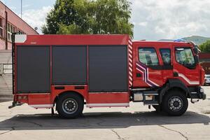 A state-of-the-art firetruck, equipped with advanced rescue technology, stands ready with its skilled firefighting team, prepared to intervene and respond rapidly to emergencies, ensuring the safety photo