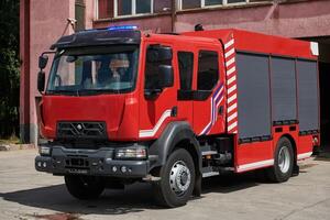 A state-of-the-art firetruck, equipped with advanced rescue technology, stands ready with its skilled firefighting team, prepared to intervene and respond rapidly to emergencies, ensuring the safety photo