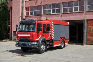 A state-of-the-art firetruck, equipped with advanced rescue technology, stands ready with its skilled firefighting team, prepared to intervene and respond rapidly to emergencies, ensuring the safety photo