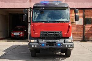 A state-of-the-art firetruck, equipped with advanced rescue technology, stands ready with its skilled firefighting team, prepared to intervene and respond rapidly to emergencies, ensuring the safety photo